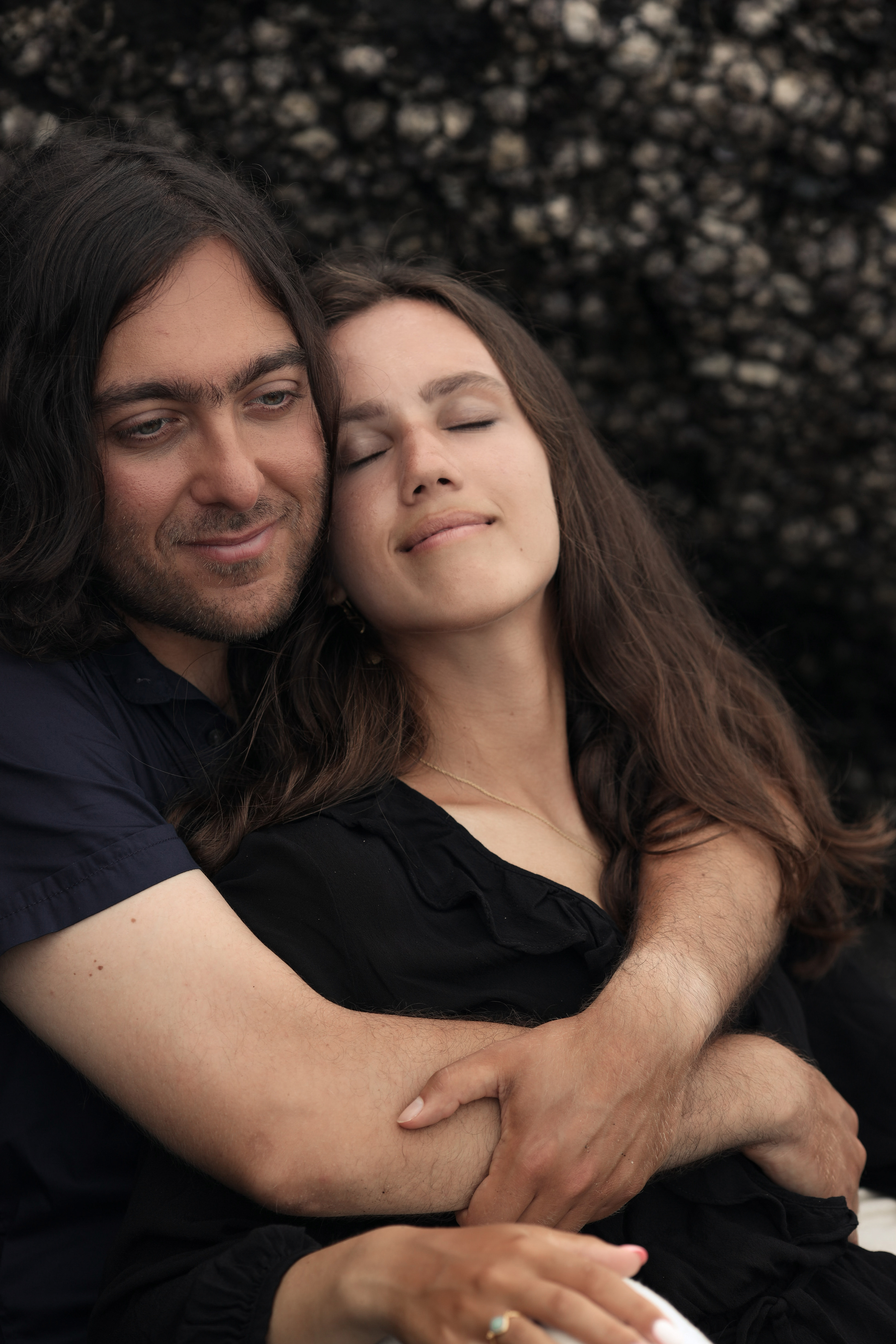 Close-up portrait of the couple embracing with soft expressions