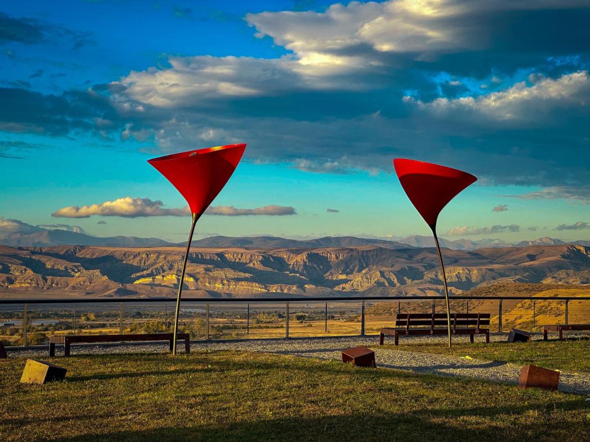 Our wedding venue with stunning mountain views and distinctive red sail structures overlooking a breathtaking landscape